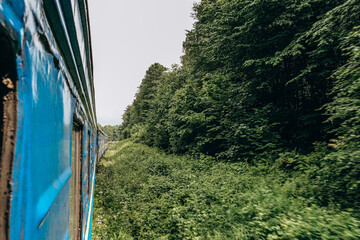 Travel to the mountains by train in summer. Beautiful scenery from the train window.