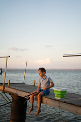 Young cute boy fishing on a lake in a summer day. Fishing
