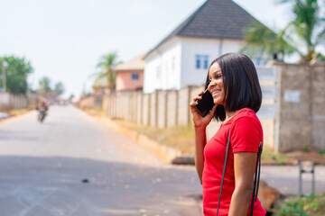 pretty african lady making a phone call smiling
