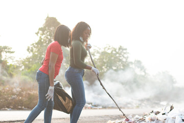 african women cleaning a refuse dump together