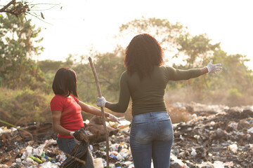 african women cleaning a refuse site