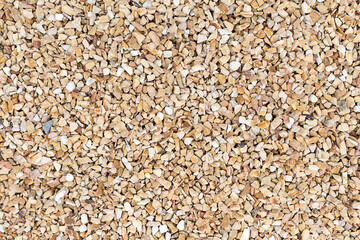 Sea pebbles. Small stones gravel texture yellow background