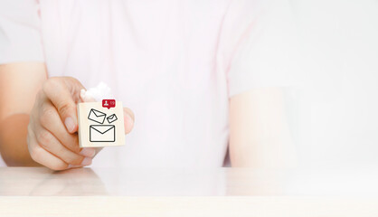 businessman chooses email icons being notification bell for incoming mail messages. Hand holding...