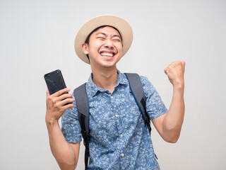 Asian man traveler hold mobile phone feels satisfied happy about booking holiday success isolated