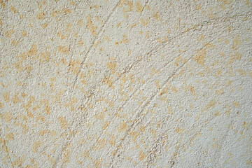 Texture of beige wall with applied plaster and scratches from time to time.