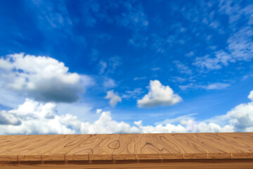 Empty wooden planks with blurred sky background. Products can be pasted or cut to display.