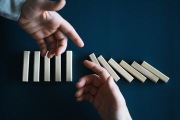 Closeup thick domino wood block in a row stop the falling, be stable in crisis, business solution concept