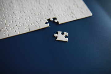 Clean puzzle elements on the background. Empty puzzle piece on the table. Teamwork concept.