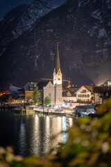 Wonderful small church on bank of a lake illuminated during night, detail, Hallstatt, Austria, Europe