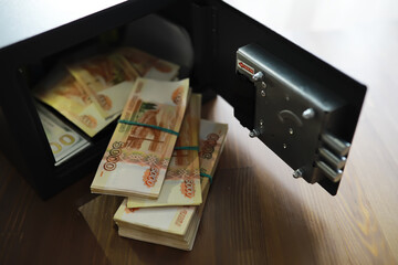 money in a residential safe close-up photo. Deposit in cash. Russian rubles are in the safe