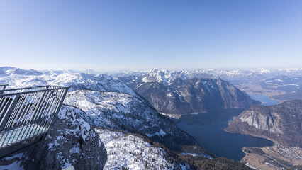 Viewing platform above winter alpine landscape with valley, mountains and lake, Austria, Europe