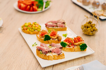 sandwiches with meat and vegetables. catering for the holiday. buffet menu.