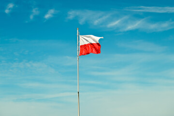 Polish flag. national flag of poland on blue sky.