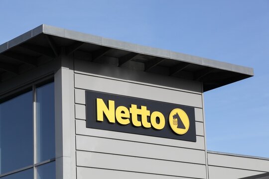 Odder, Denmark - October 22, 2021: Netto sign on a building. Netto is a Danish discount supermarket operating in several European countries. Netto is owned by Dansk Supermarked Group
