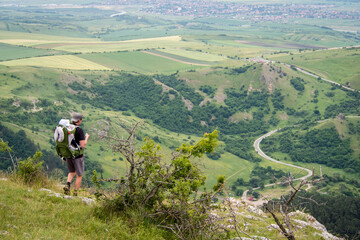 Hiking with baby in backpack in magic mountains of Transylvania, Romania