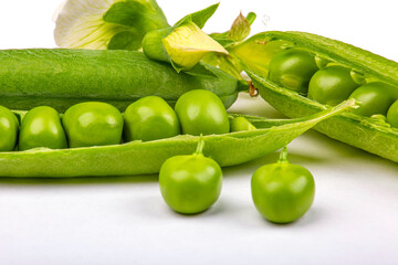 An open pod of green peas, on a white background, macro photography