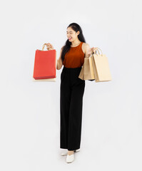 Young pretty asian woman long hair carrying and holding red and brown paper shopping posing full body on white background.