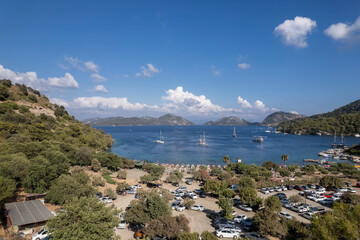 sarsala beach bay dalaman Mediterranean bay with hills and pine forest blue water and boats