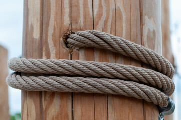 Fototapeta na wymiar Rope wrapped around wooden post in snow