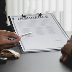 Car dealers or managers allow customers to sign documents and car sales agreements with insurance. Document signing and credit approval Concept..