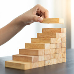 Arrange the wooden blocks into steps, higher the marketing strategy the more effort is required, Driving business at the peak concept.