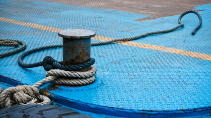 Boat rope tied up on a bitt Large steel bollard at the harbour