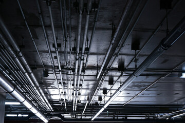 Sanitary system pipes and electrical cables installed under flat slab reinforced concrete structure...