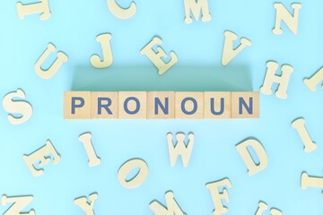Pronoun concept in English grammar and learning class lesson. Wooden blocks typography word flat lay in blue background.