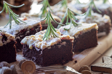 Viele leckere Kuchenstücke Brownies mit weißer Schokolade, verziert mit Rosmarin als Tannenbaum zur Adventszeit