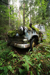 Fototapeta premium Old, forgotten car in Finnish forest. 