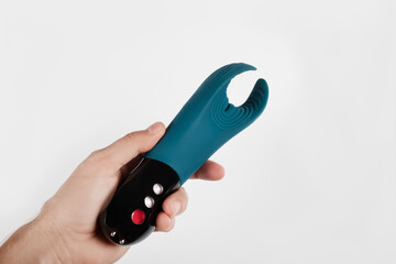 Man holding Silicone sex toys on a white background. Erotic toy for fun. Sex gadget and...