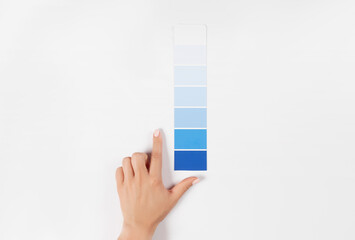 Hand holding Color samples palette design catalog.