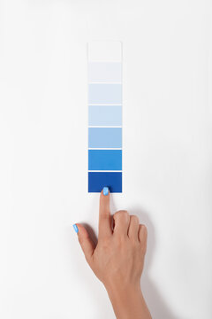 Hand holding Color samples palette design catalog.