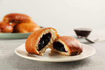 Delicious baked patty with jam on light grey table