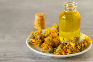 Dried marigold flowers and oil for natural treatments or cosmetic industry
