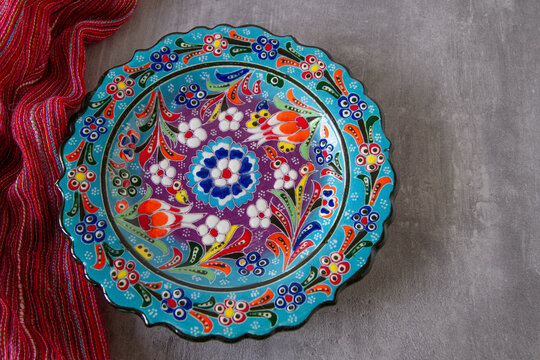 Plate with brightly colored oriental motifs on a table