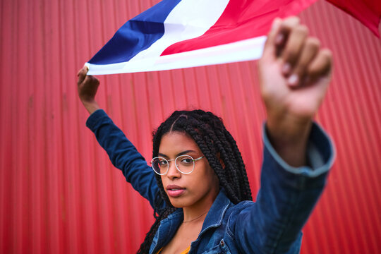 Ethnic woman with Dominican Republic flag on red background