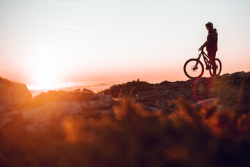 Man riding on bike on hill