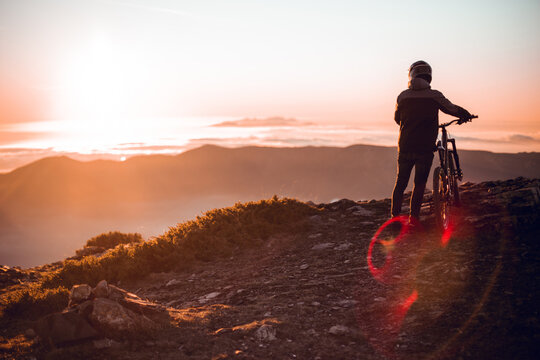 Man riding on bike on hill