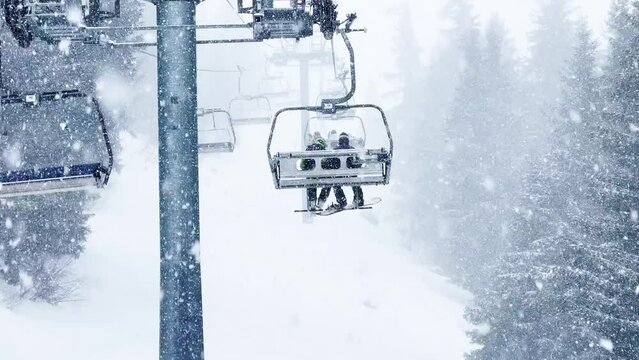 Heavy snowfall at alpine resort ski lift ropeway