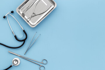 Dental or surgical steel instruments with stethoscope. Healthcare background