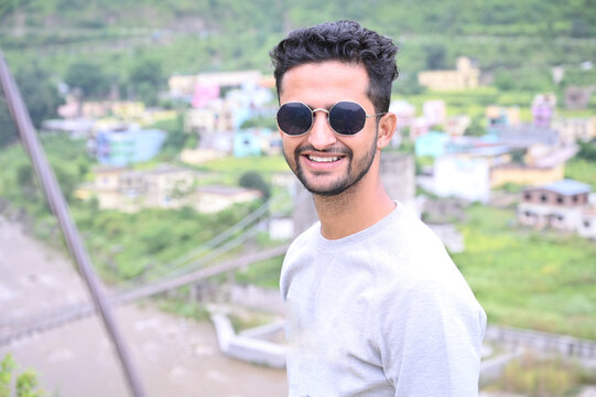 a indian boy happily, smiley face with sunglasses.