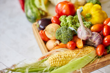 Wooden box with different fresh farm vegetables on the white background, Autumn harvest and healthy organic bio food concept, Garden produce and harvested vegetable