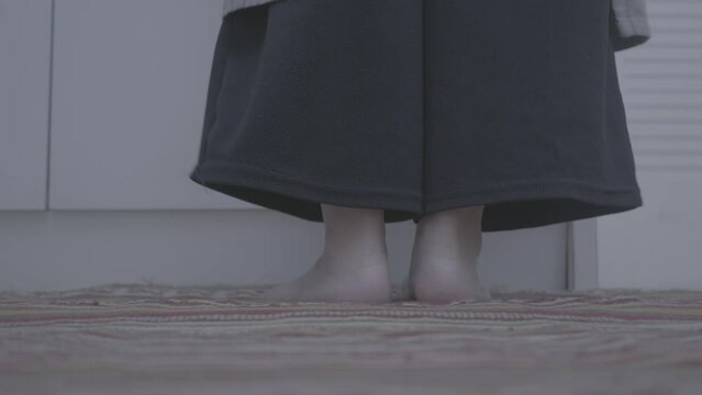 a girl's feet tiptoe to pick something up