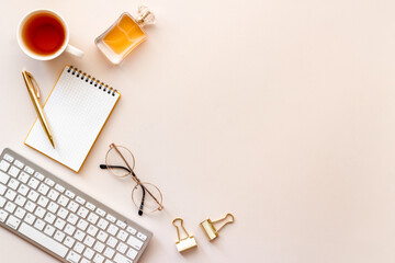 Layout of blogger or designer desktop with computer and golden colored office supplies