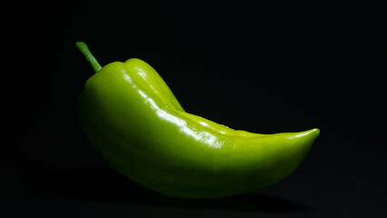 green pepper on black background