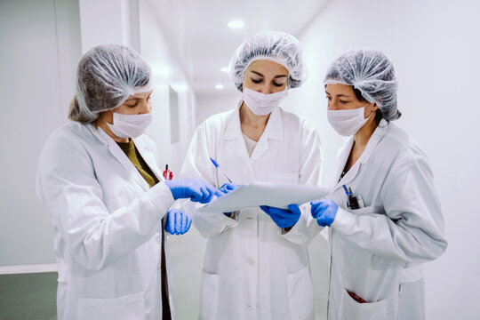 Women With Papers In Lab