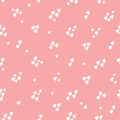 Small white hearts on light pink background. Simple seamless pattern. Fashionable print for textiles and wallpaper.