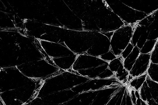 Cracks in the glass on black background.