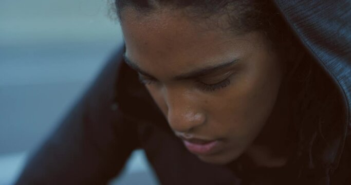 Fitness athlete girl tired from exercise, young black woman taking health break and difficult sport running workout. Strong runner with headphones sweating, rest breath and accept training challenge